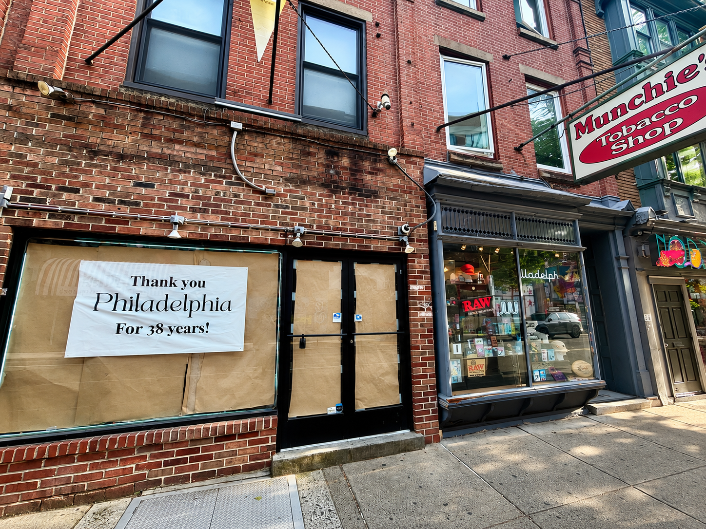 Photograph of South Street on the 200 block in 2026, showing a mix of vacant and active storefronts.